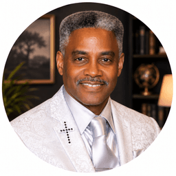 Eddie C. Walker, founder of Tribe of Judah Family Resource Center, in a white blazer with a cross lapel pin