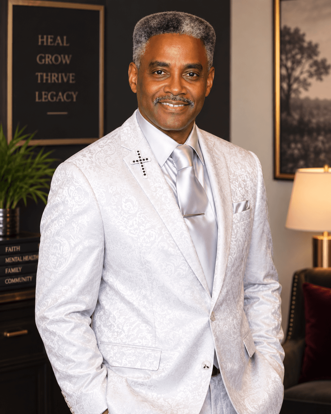 Eddie C. Walker, founder of Tribe of Judah Family Resource Center, in a white blazer with a cross lapel pin