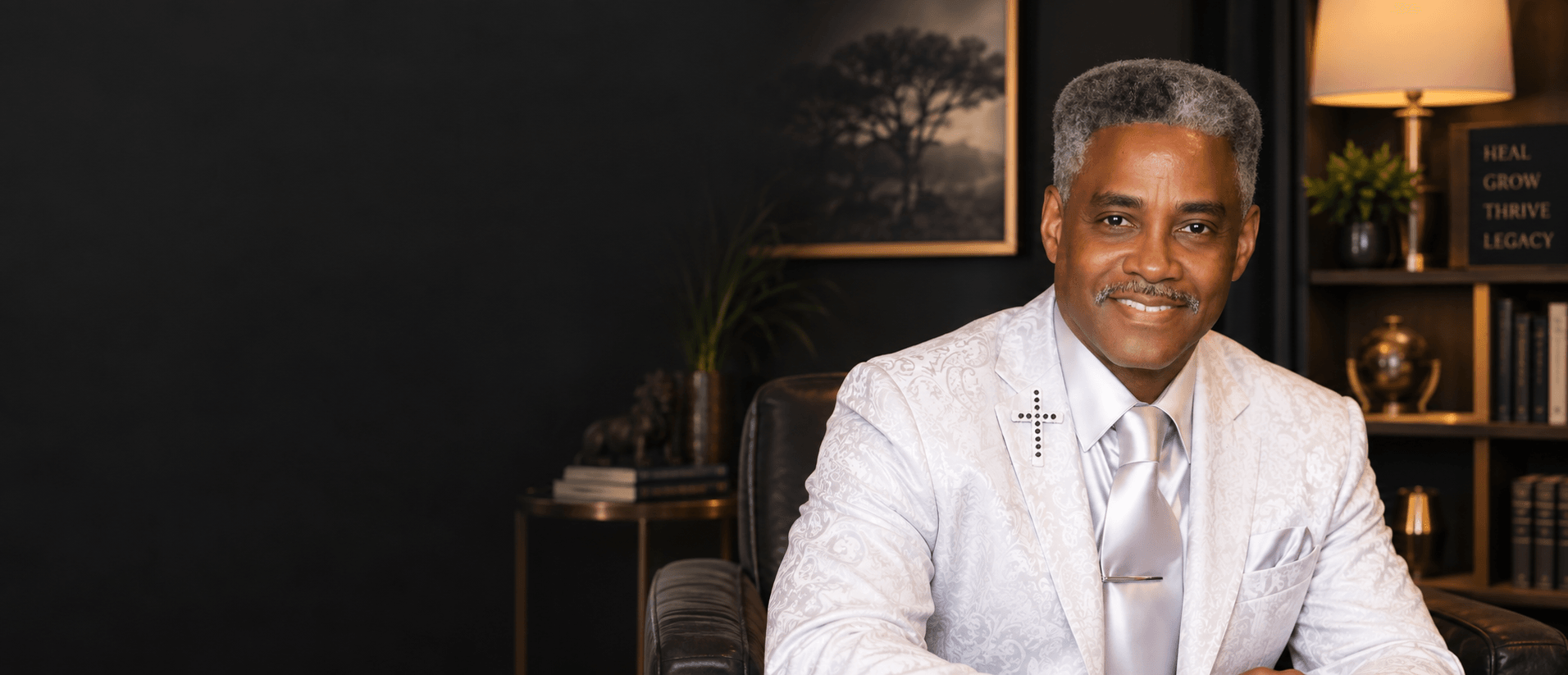 Eddie C. Walker, founder of Tribe of Judah Family Resource Center, in a white blazer with a cross lapel pin